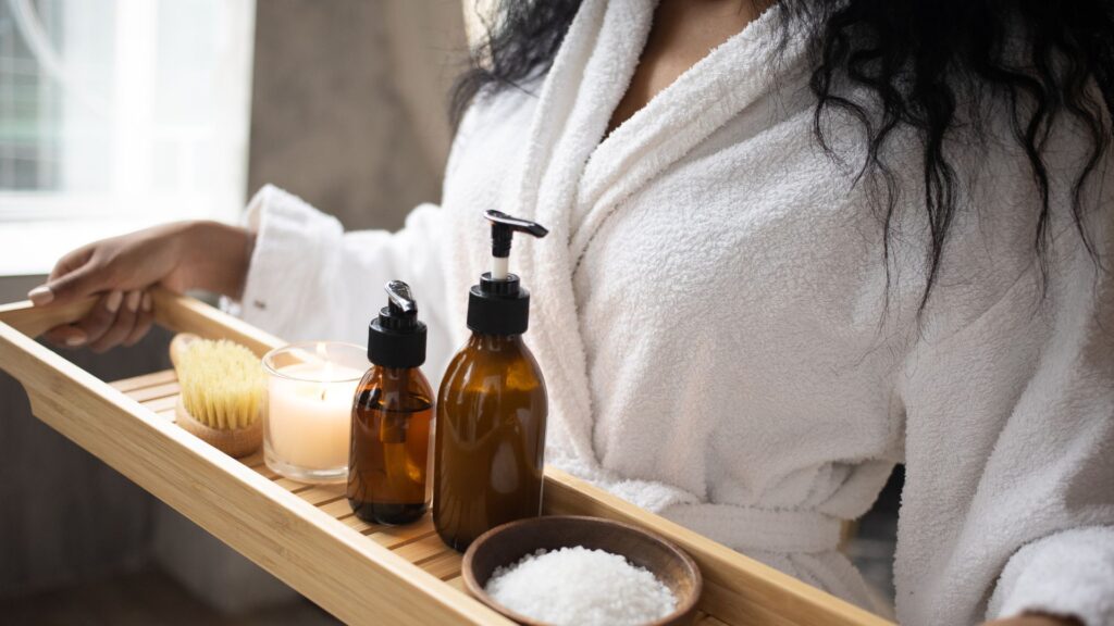 image showing a woman at a spa seeing a beauty therapist and carrying spa supplies in a room