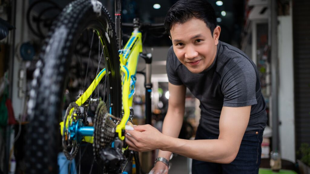 image showing a bicycle mechanic working on a bike wheel