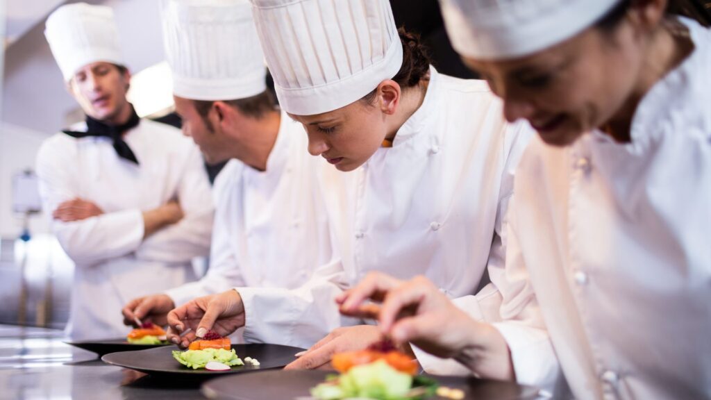 image showing a line of chef de parties learning how to cook
