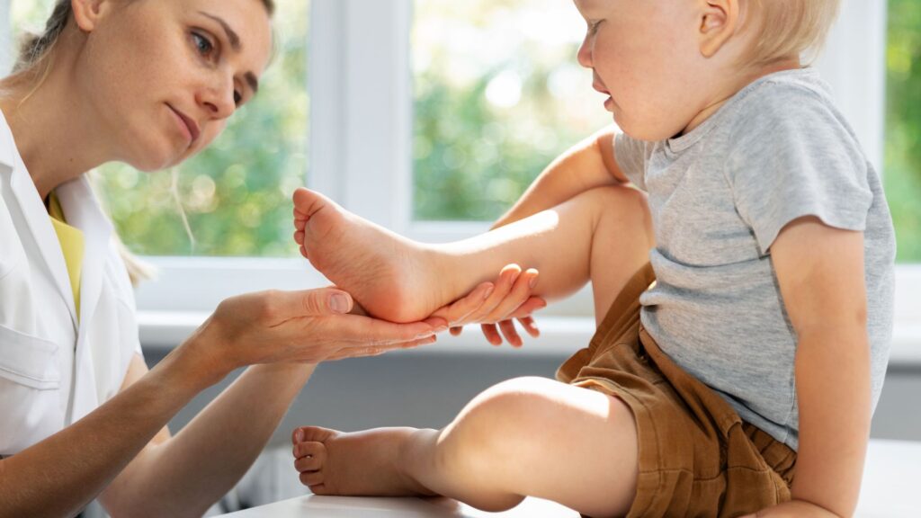 image showing a chiropodist inspecting foot of a child patient