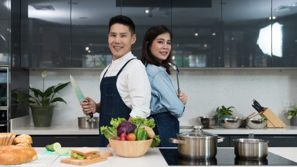 image showing a commis chef in a kitchen with an assistant chef helper