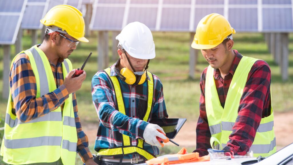 image showing an energy consultant speaking to coworkers in a solar field