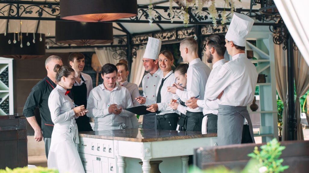 image showing a head chef talking to other chefs in a kitchen