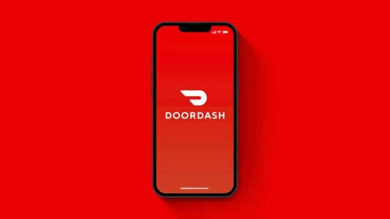 image showing a doordash logo on the screen of a smartphone - header for doordash background check post