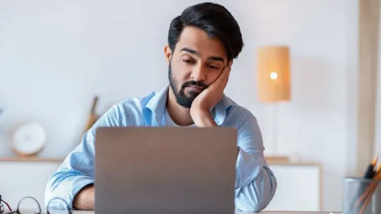 image showing a person bored at work